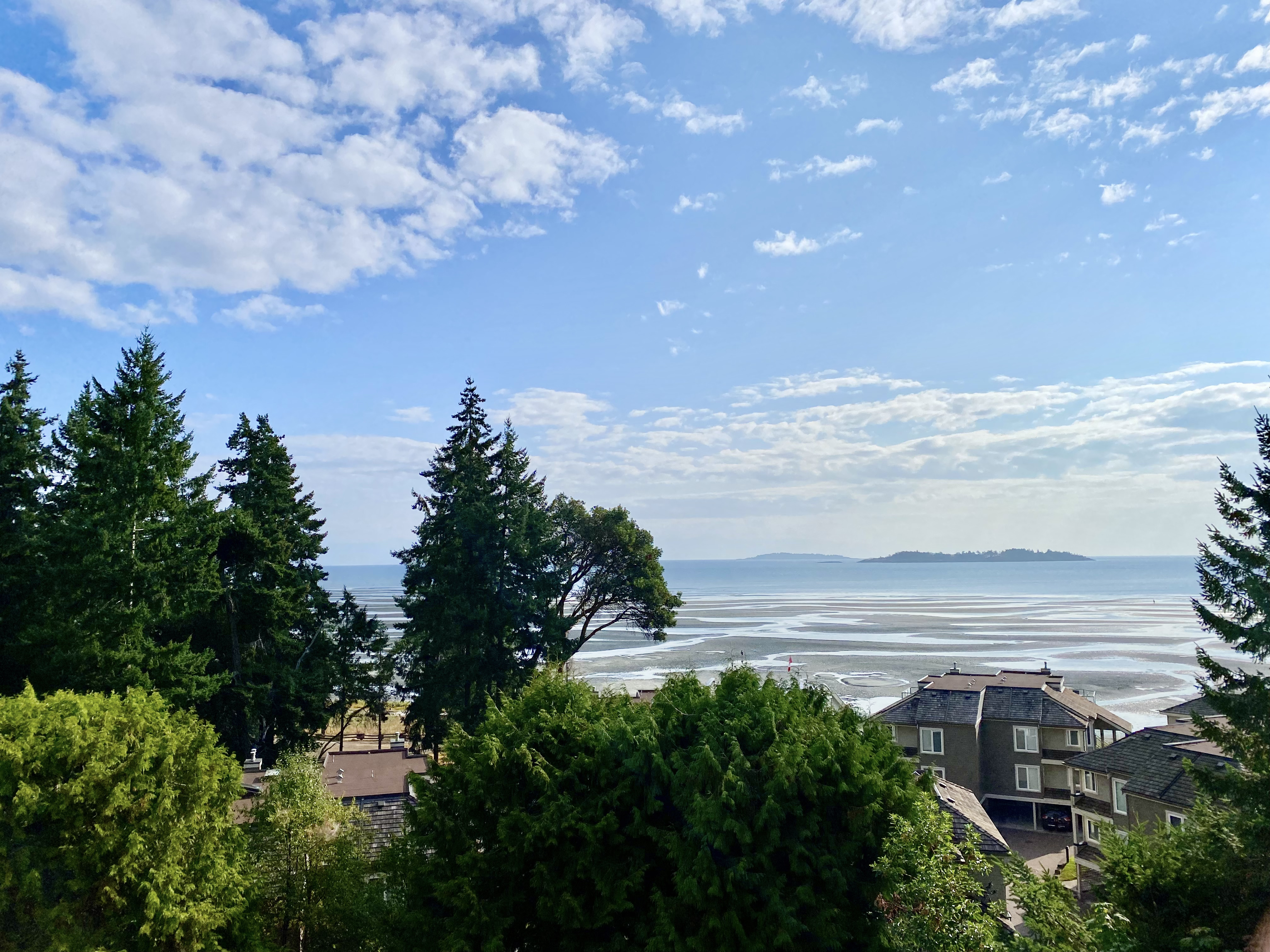 Blue sky and calm coastal waters at Rathtrevor Beach in Parksville